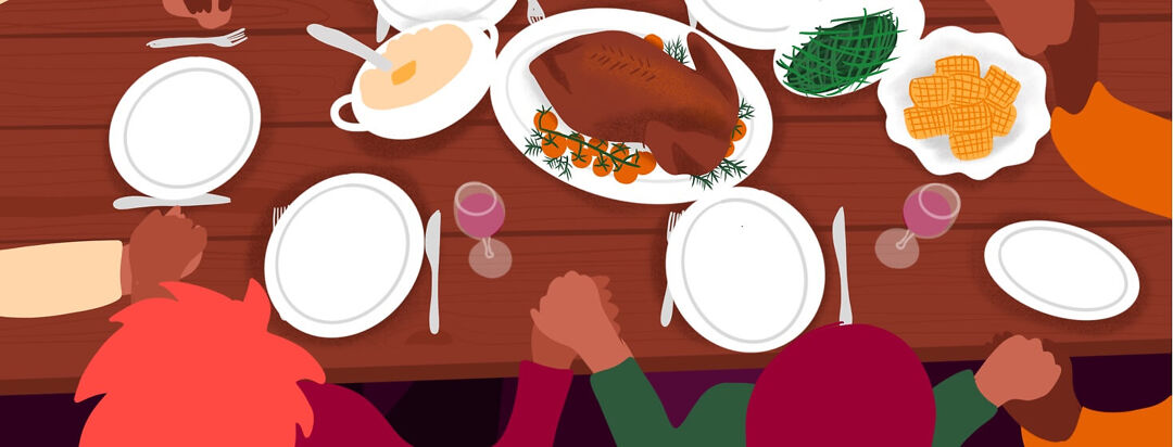 Family holds hands around a holiday dinner table