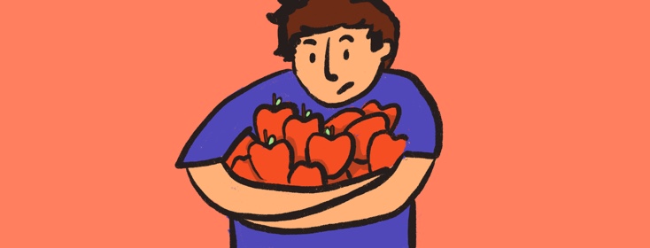 A man holding a bunch of red apples