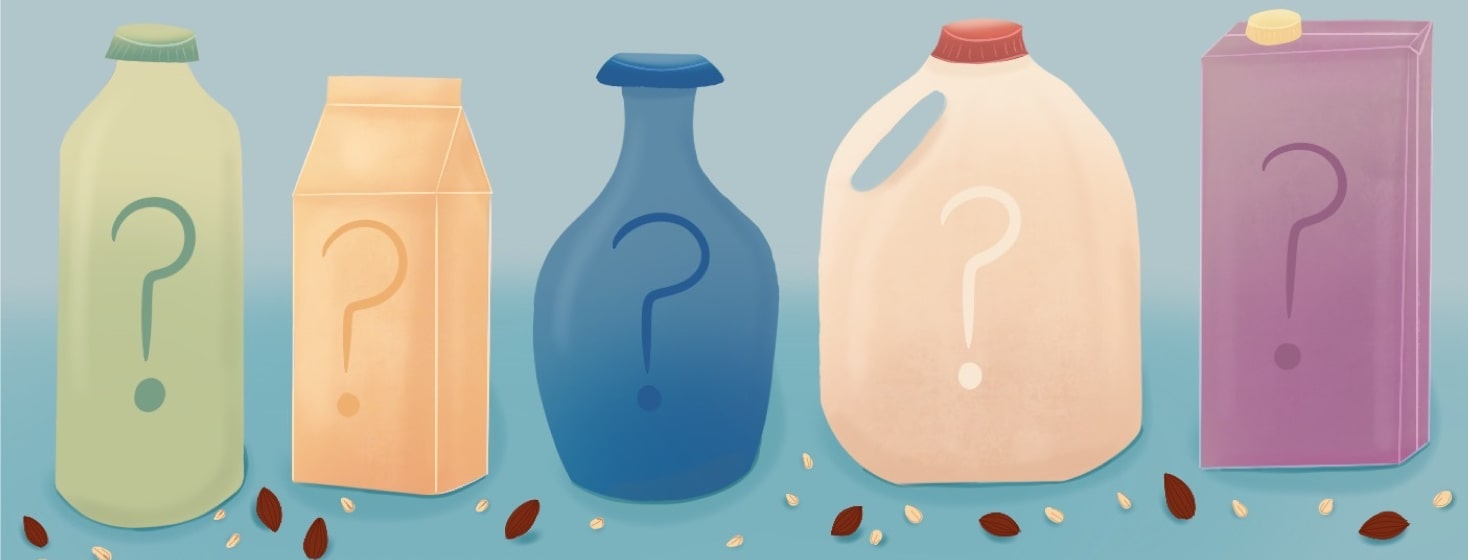Variety of milk containers with question marks on them surrounded by almonds and oats