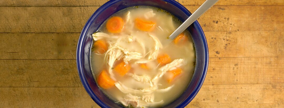 Chicken stew in a bowl with spoon.