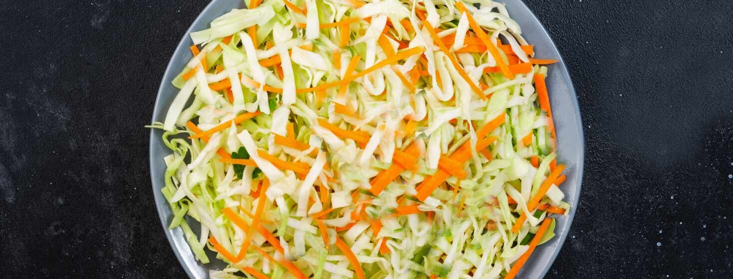 Spring roll ingredients in bowl. Cole slaw.