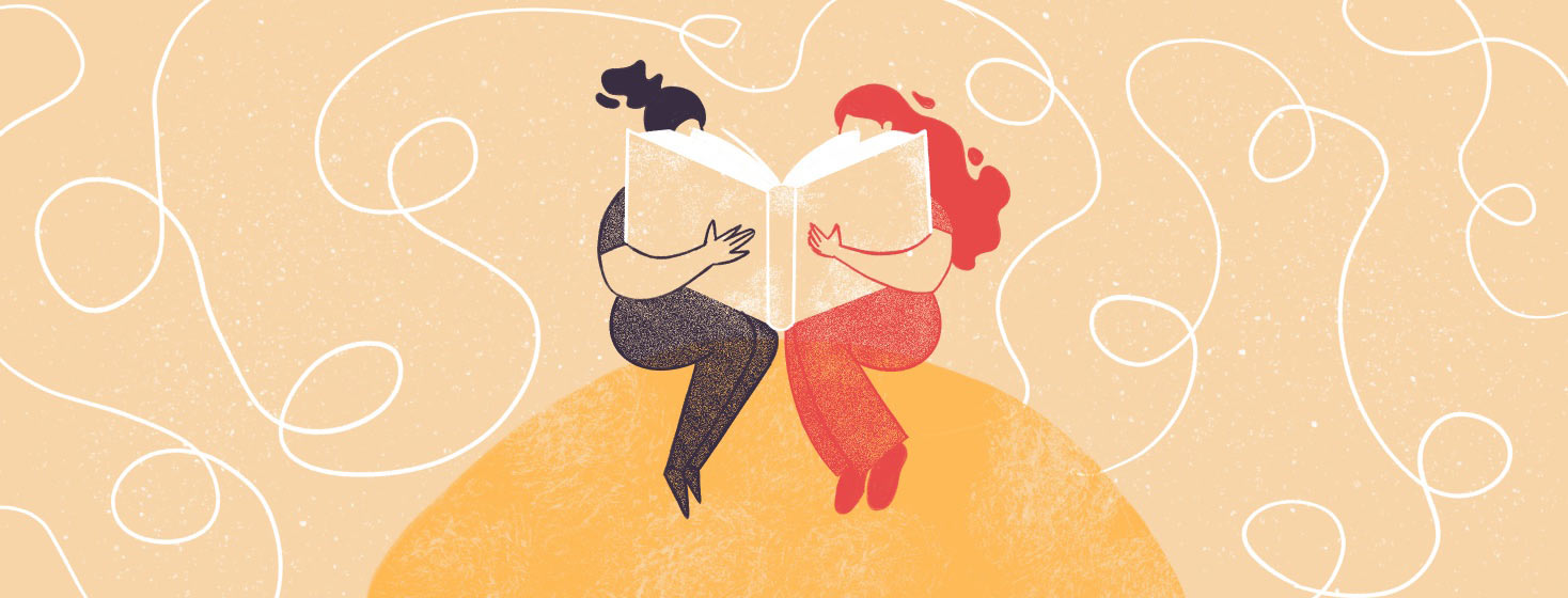 Two women reading a huge book together.