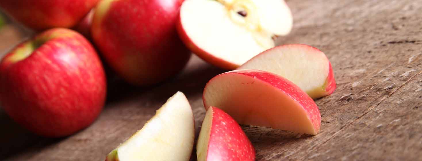 Apples and apple slices on tabletop